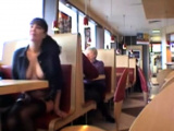 Busty babe flashing in a restaurant