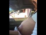 mature woman touches her big boob rolling next to a trucks